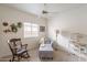 Comfortable bedroom with a daybed, rocking chair and neutral walls and carpet flooring at 10332 W Potter Dr, Peoria, AZ 85382