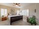 Serene bedroom featuring a dark wood bed frame, carpet flooring, and plantation shutters at 10332 W Potter Dr, Peoria, AZ 85382