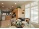 Bright breakfast nook features wooden cabinets, a glass table, and natural light through plantation shutters at 10332 W Potter Dr, Peoria, AZ 85382