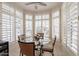 Cozy breakfast nook filled with natural light from the bay window with modern lighting and furniture at 10332 W Potter Dr, Peoria, AZ 85382