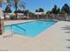 A spacious community pool with clear blue water, surrounded by a deck and a fence for safety and privacy at 10332 W Potter Dr, Peoria, AZ 85382