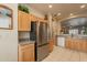 An eat-in kitchen features granite countertops, stainless steel appliances, and wood cabinetry at 10332 W Potter Dr, Peoria, AZ 85382