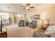 Spacious living room featuring neutral walls, plush carpeting, ceiling fan and two comfortable armchairs at 10332 W Potter Dr, Peoria, AZ 85382