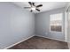 Neutral bedroom with carpet, ceiling fan, window, and closet with white sliding doors at 10704 E Plata Ave, Mesa, AZ 85212