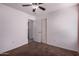 Bedroom featuring brown carpet, ceiling fan, and access to a closet and adjoining room at 10704 E Plata Ave, Mesa, AZ 85212