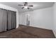 Neutral bedroom with a ceiling fan, carpeted floor, and a window providing natural light at 10704 E Plata Ave, Mesa, AZ 85212