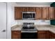 Kitchen featuring stainless steel appliances, granite countertops, and ample cabinet space at 10704 E Plata Ave, Mesa, AZ 85212