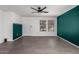 Bright living room with gray tile flooring, a front door view, and green accent wall at 10704 E Plata Ave, Mesa, AZ 85212