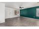 Bright living room with gray tile flooring, a front door view, and green accent wall at 10704 E Plata Ave, Mesa, AZ 85212