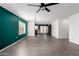 Spacious living room with stylish gray tile flooring, ceiling fan, and green accent wall at 10704 E Plata Ave, Mesa, AZ 85212