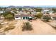 Aerial view of home with large lot, trailer, and construction equipment at 11512 E 6Th Ave, Apache Junction, AZ 85120