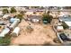 Aerial view of home with a large lot needing landscaping, surrounded by fencing at 11512 E 6Th Ave, Apache Junction, AZ 85120