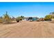 A vast dirt backyard featuring construction equipment and trailers, under a clear blue sky at 11512 E 6Th Ave, Apache Junction, AZ 85120