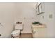 Functional bathroom with a standard toilet, sink, vanity, and above-the-sink cabinet at 11512 E 6Th Ave, Apache Junction, AZ 85120