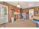 An inside view of bonus room with wood paneling, and stone accented corner fireplace at 11512 E 6Th Ave, Apache Junction, AZ 85120