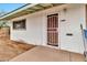 The house front door features a screen and a storm door with a window above it at 11512 E 6Th Ave, Apache Junction, AZ 85120