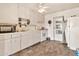 Angle of kitchen with white appliances including a microwave, stove, and refrigerator at 11512 E 6Th Ave, Apache Junction, AZ 85120