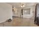 Spacious living room with bare floors, a ceiling fan and a view to the kitchen at 11512 E 6Th Ave, Apache Junction, AZ 85120