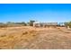 View of property featuring open land, a large storage building, and distant homes in the neighborhood at 11512 E 6Th Ave, Apache Junction, AZ 85120