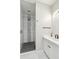 Modern bathroom featuring glass shower, white vanity, dark fixtures, and geometric tile accents at 12201 N 66Th St, Scottsdale, AZ 85254