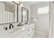 Bright bathroom featuring double sinks, white countertops, black plumbing, and a shower at 12201 N 66Th St, Scottsdale, AZ 85254