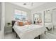 Bright bedroom featuring a mirrored closet, a white bed, and a window with lots of light at 12201 N 66Th St, Scottsdale, AZ 85254