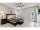 This is a spacious bedroom with a ceiling fan, ensuite bath, and neutral colors at 12201 N 66Th St, Scottsdale, AZ 85254