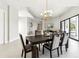 This is a dining room featuring a modern chandelier and an adjacent living area at 12201 N 66Th St, Scottsdale, AZ 85254