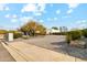 Wide, circular driveway leading to a modern home with desert landscaping and a blue sky at 12201 N 66Th St, Scottsdale, AZ 85254