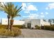 Modern white home with desert landscaping, a circular driveway, and a clear blue sky at 12201 N 66Th St, Scottsdale, AZ 85254