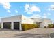 Modern white home with a two-car garage, desert landscaping, and a blue sky backdrop at 12201 N 66Th St, Scottsdale, AZ 85254