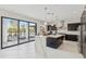 Bright, modern kitchen with marble waterfall island, dark cabinetry, and stainless steel appliances at 12201 N 66Th St, Scottsdale, AZ 85254