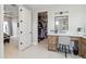 Bathroom vanity with a makeup station, a walk-in closet, and an open view to another bedroom at 12201 N 66Th St, Scottsdale, AZ 85254