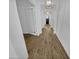 Hallway with wood-look tile flooring and decorative pendant lighting at 12858 W Pasaro Dr, Peoria, AZ 85383