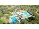 Stunning aerial view of the community pool with palm trees and shade umbrellas at 12858 W Pasaro Dr, Peoria, AZ 85383