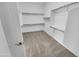 Spacious walk-in closet with ample shelving and carpeting for organized storage at 12858 W Pasaro Dr, Peoria, AZ 85383