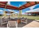 Inviting outdoor pavilion features comfortable seating around a fire pit, perfect for relaxing and entertaining at 13170 E Verbina Ln, Florence, AZ 85132