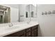 Bathroom features double vanity sinks, neutral walls, and coat hooks at 13849 S 179Th Ave, Goodyear, AZ 85338