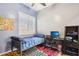 Bedroom with colorful rug, neutral walls, shuttered windows, and workstation at 13849 S 179Th Ave, Goodyear, AZ 85338