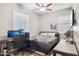 Bedroom with desk, TV, neutral walls, and shuttered windows at 13849 S 179Th Ave, Goodyear, AZ 85338