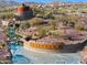 Aerial view of Estrella community entrance featuring stone signage, water feature and desert landscape at 13849 S 179Th Ave, Goodyear, AZ 85338