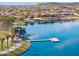 Aerial view of a community lake featuring a boat dock and walking paths at 13849 S 179Th Ave, Goodyear, AZ 85338