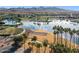 Aerial view of a community park featuring a lake, fountains, and walking paths at 13849 S 179Th Ave, Goodyear, AZ 85338