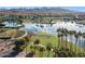 Inviting community pool and lake with fountains, surrounded by lush landscaping and palm trees at 13849 S 179Th Ave, Goodyear, AZ 85338