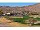 Aerial view of the golf course featuring greens, sand traps, clubhouse and desert landscape at 13849 S 179Th Ave, Goodyear, AZ 85338