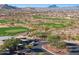 Aerial view of community golf course and cart parking, nestled among residential homes at 13849 S 179Th Ave, Goodyear, AZ 85338