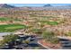 Scenic view of well-maintained golf course with lush greens, surrounded by desert landscape and luxurious homes at 13849 S 179Th Ave, Goodyear, AZ 85338