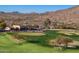 Picturesque golf course featuring manicured greens, sand traps and clubhouse with parking at 13849 S 179Th Ave, Goodyear, AZ 85338