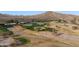 Aerial view of the golf course featuring greens, sand traps, and clubhouse at 13849 S 179Th Ave, Goodyear, AZ 85338