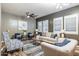 Comfortable living room featuring a ceiling fan, shutters on the windows, and modern decor at 13849 S 179Th Ave, Goodyear, AZ 85338